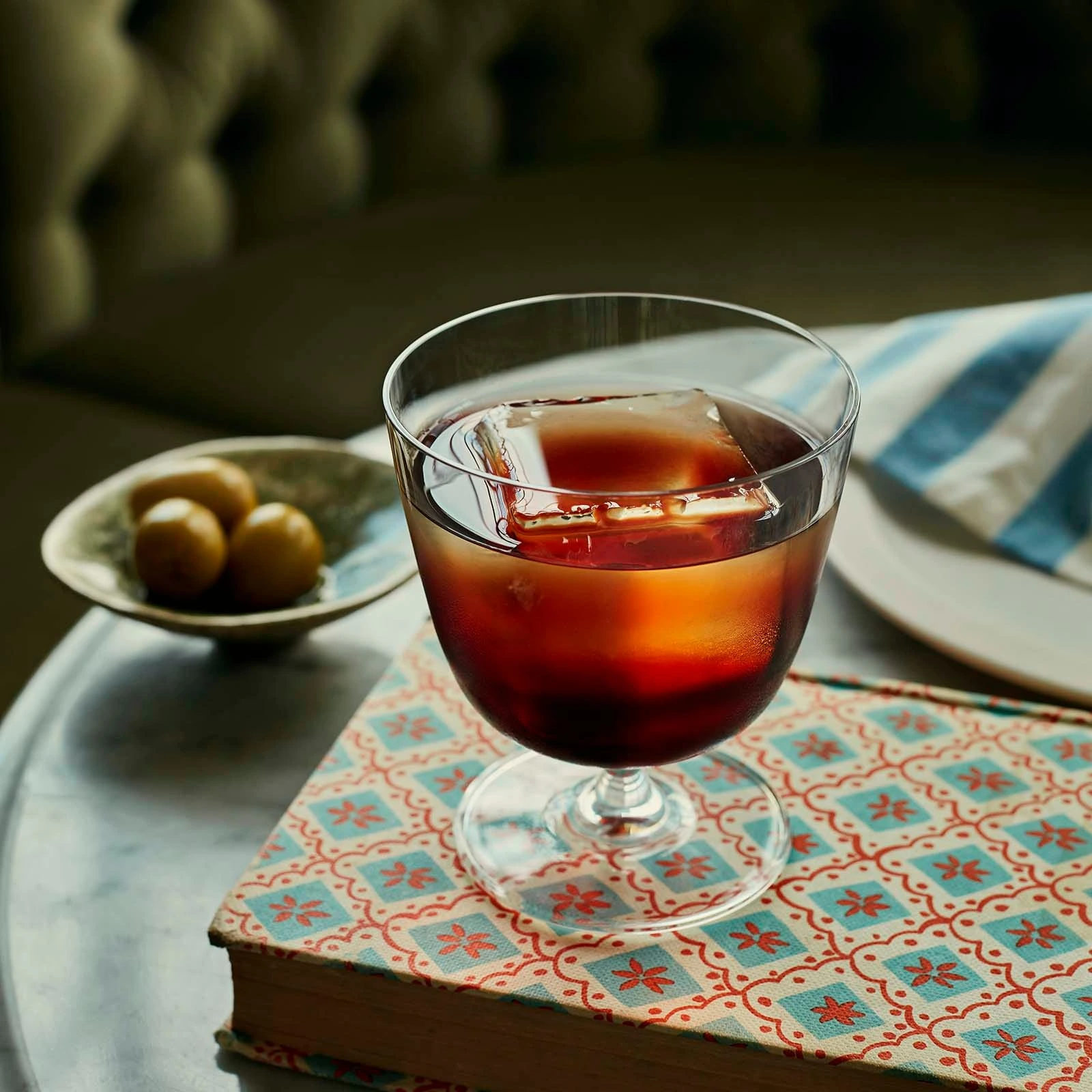 Bargiani 320ml old fashioned glass by NUDE with a dark drink on a table