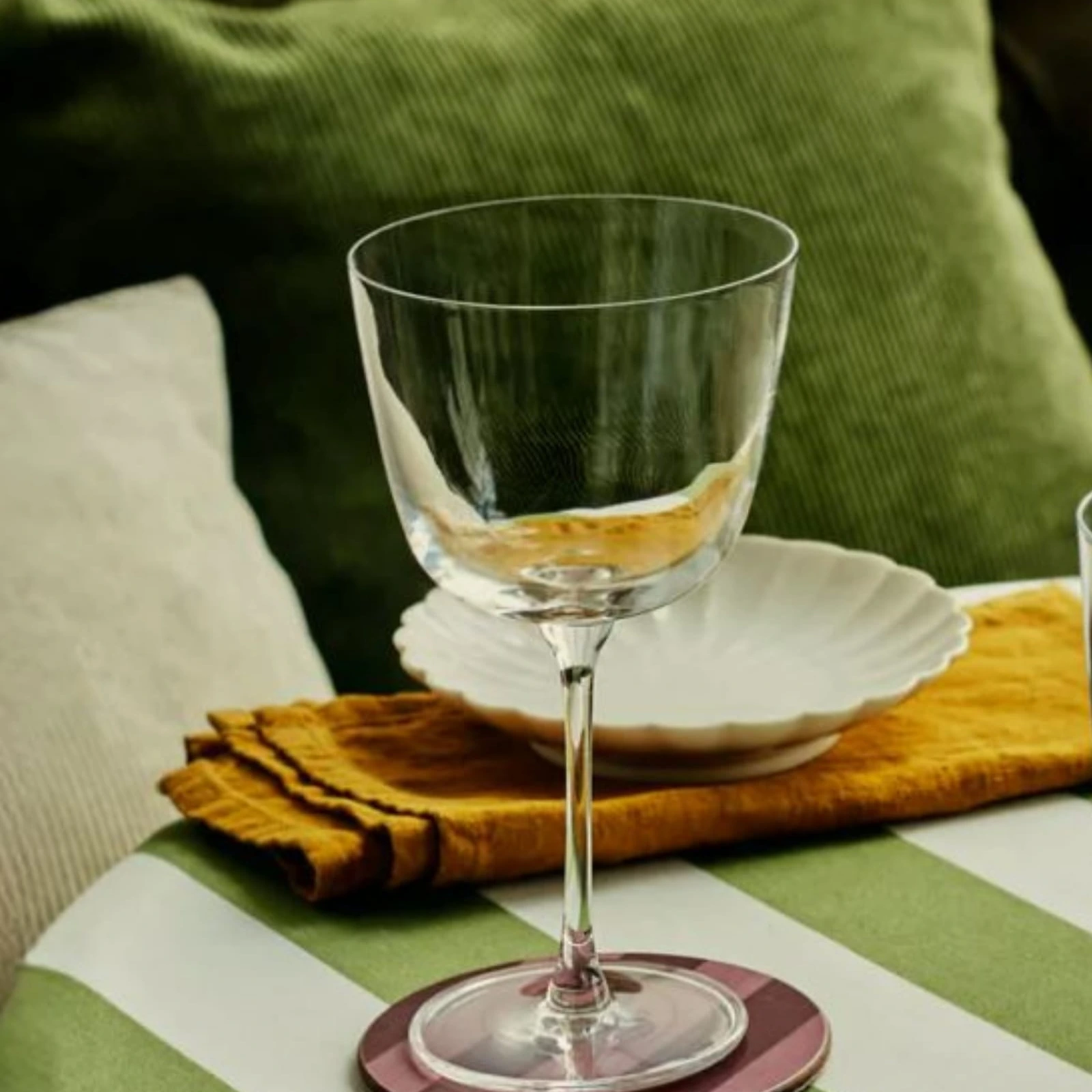 Bargiani 330ml spritz glass by NUDE with a drink on a table